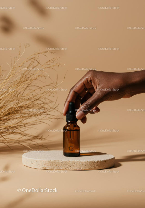 Minimalist Brown Dropper Bottle with Hand Holding Essential Oil JPG Mockup Image