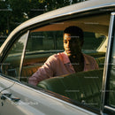 Young Man in Pink Shirt Sitting in Vintage Car on a Sunny Day