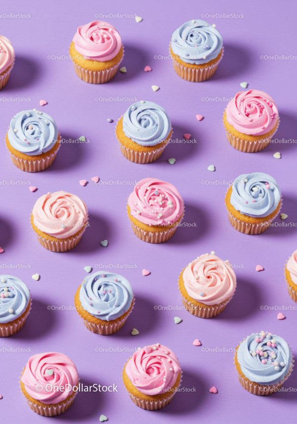 Colorful cupcakes with pastel frosting on purple background