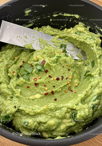 Fresh homemade guacamole with chili flakes and herbs