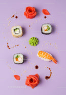 Assorted sushi rolls with garnishes on pastel background