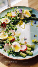 Fresh asparagus salad with soft boiled eggs and edible flowers