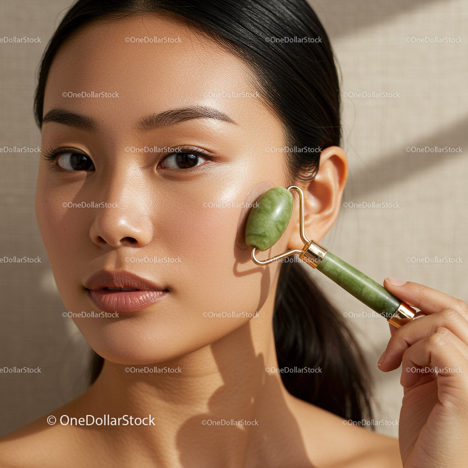 Asian Woman Using Jade Roller for Facial Skincare Therapy