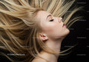 Blonde woman with flowing hair on black background