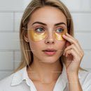 Woman Applying Gold Eye Patches for Skin Rejuvenation