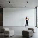 Woman standing contemplatively in spacious modern lobby