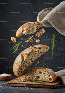 Rustic artisan bread bursting with fresh rosemary and flour