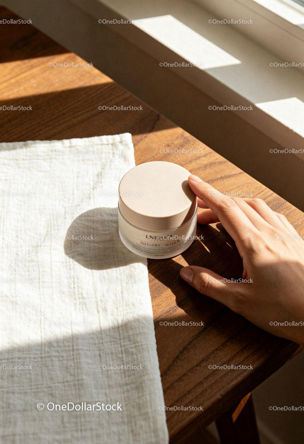 Hand Reaching for Natural Skin Care Cream on Wooden Table