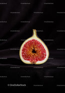 Close up of ripe fig cut in half on dark background
