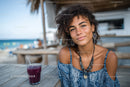 Portrait of a Smiling Young Woman at a Tropical Beachside Café
