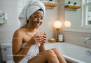 Young woman with facial mask relaxing in bathroom
