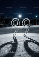 Snow-covered number 99 sculpture at night mountain ski area