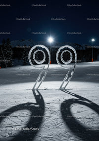 Snow-covered number 99 sculpture at night mountain ski area