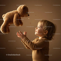 Toddler reaching for soft teddy bear toy with wonder