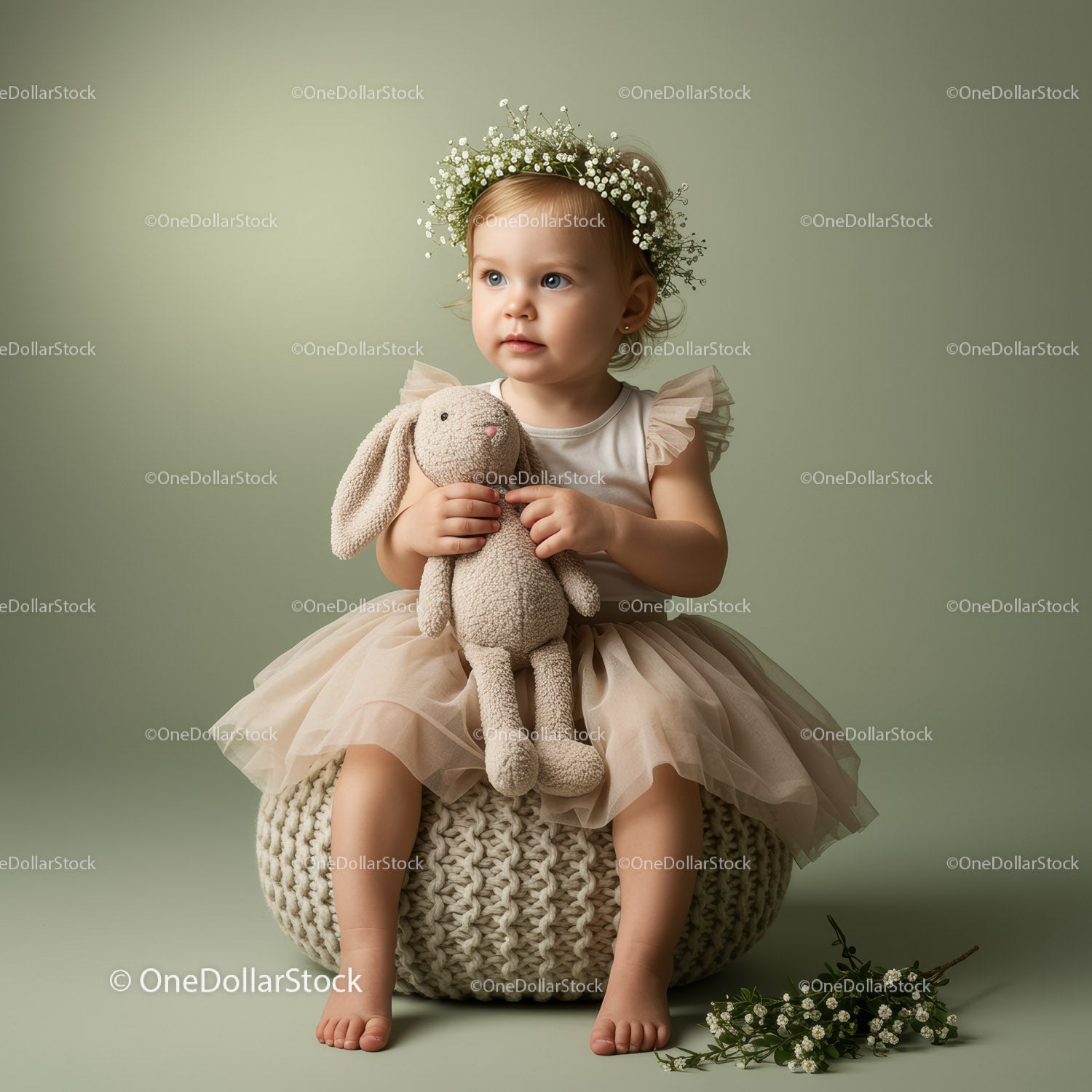 Toddler girl with flower crown holding soft bunny toy