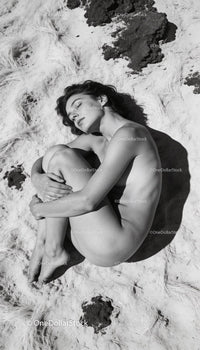 Serene woman embracing peace on textured sandy surface