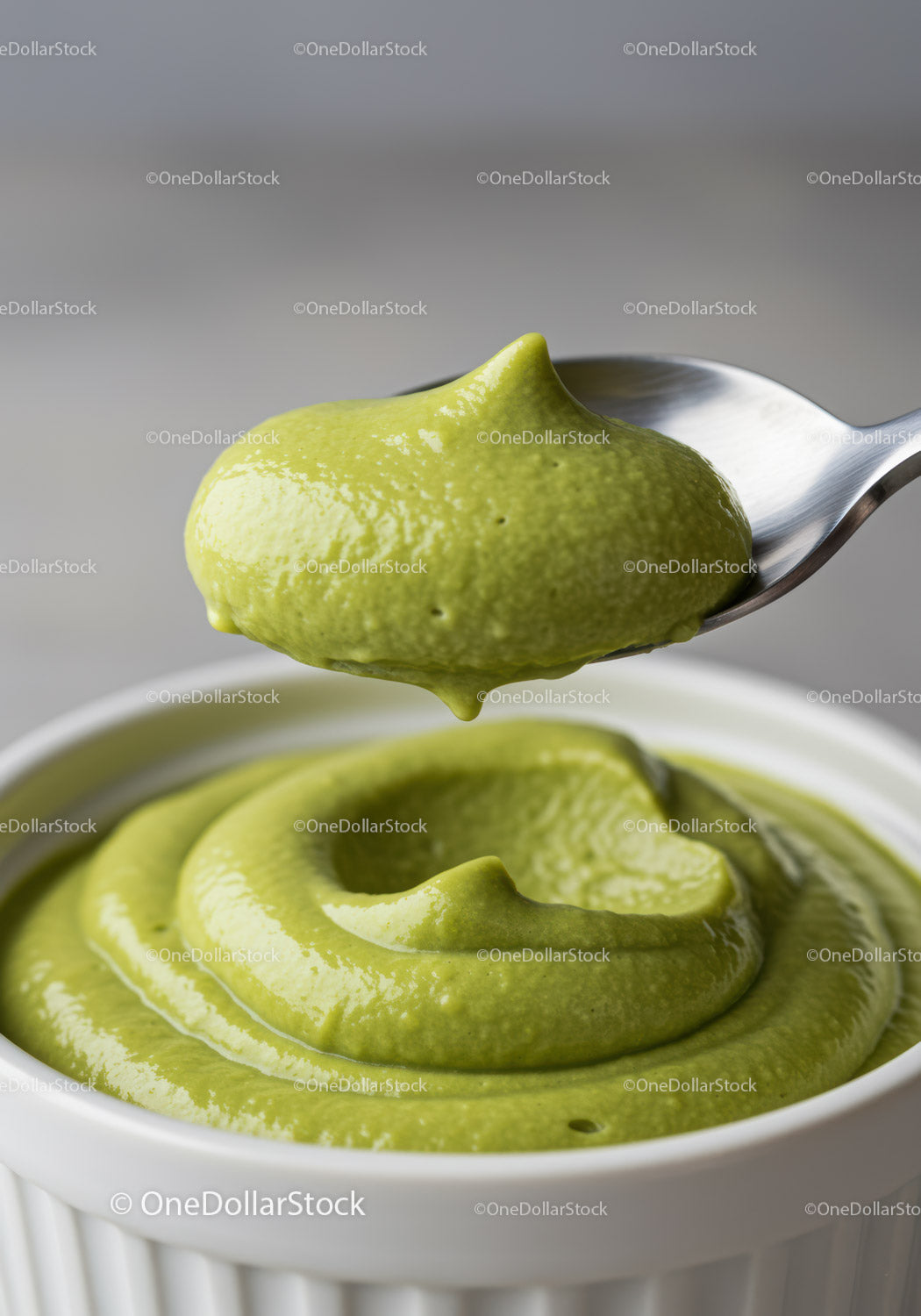Creamy Green Avocado Dip in White Bowl with Spoon