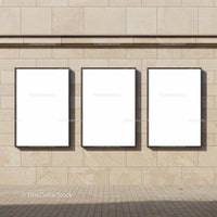 Three Blank Posters on Beige Stone Wall Outdoors