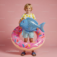 Smiling child with inflatable fish and donut float