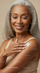 Elegant Mature Woman Applying Skin Lotion for Healthy Aging