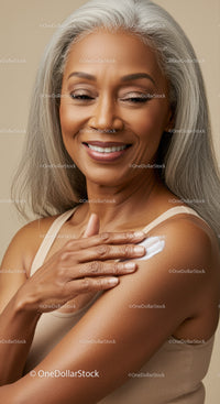 Elegant Mature Woman Applying Skin Lotion for Healthy Aging