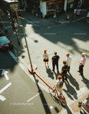 Urban Crosswalk with Pedestrians and Biker on a Sunny Day