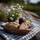 Rustic Basket of Fresh Baked Bread with Jars and Flowers in a Country Setting