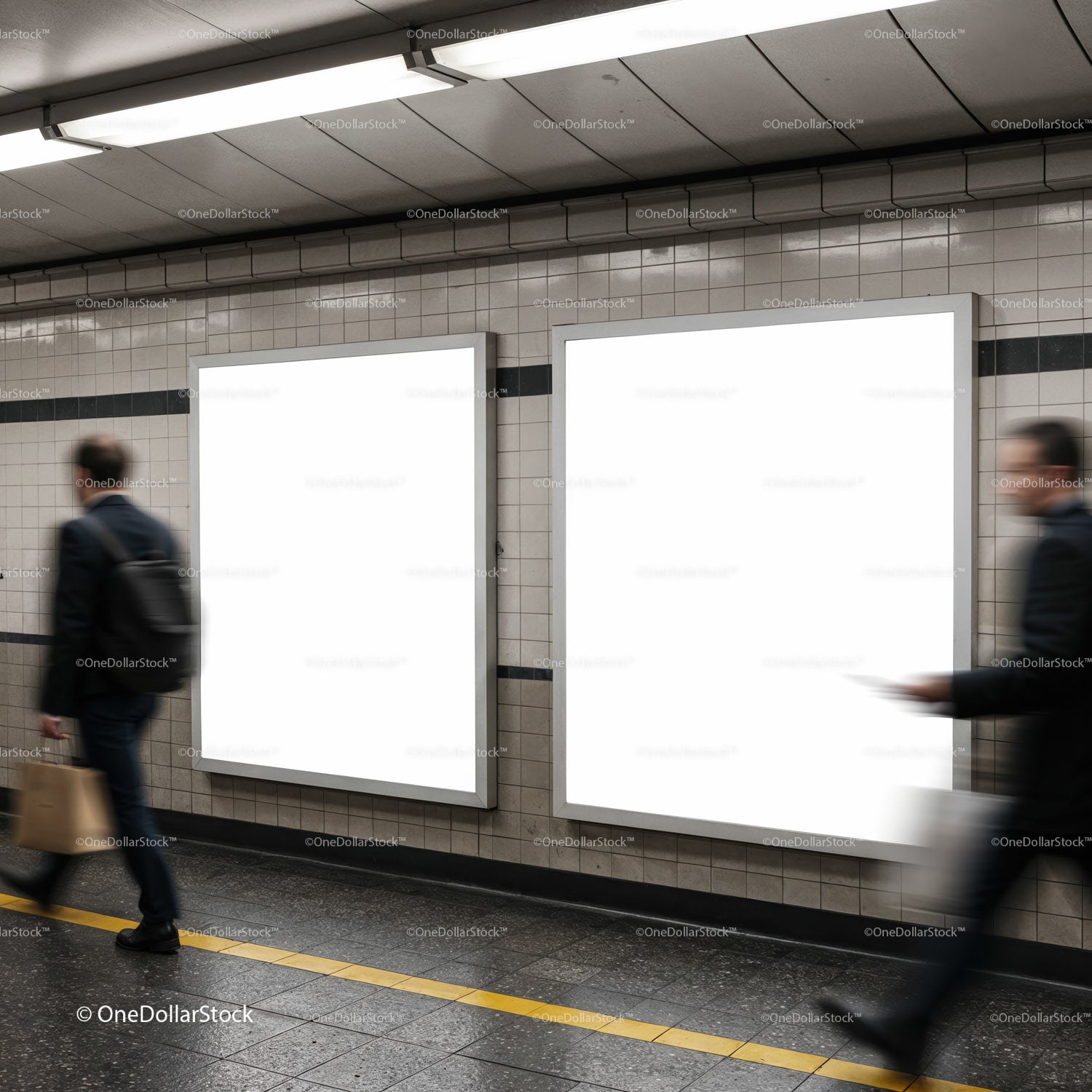 Commuters walking past blank advertising panels in subway