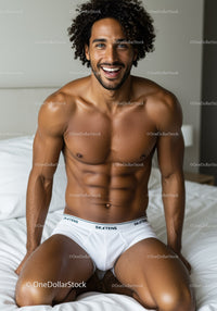 Smiling muscular man sitting on bed in white underwear