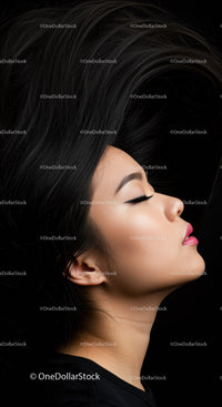 Profile of young woman with flowing black hair and closed eyes