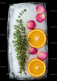 Fresh orange slices and herbs frozen in ice block