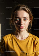 Close-up of Confident Young Woman with Blue Eyes in Yellow T-shirt