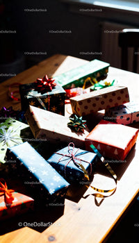 Colorful wrapped Christmas gifts arranged on wooden table