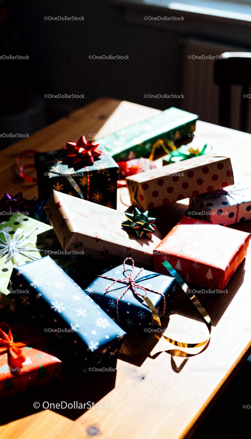 Colorful wrapped Christmas gifts arranged on wooden table