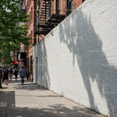 City Sidewalk with Pedestrians and Tree Shadows