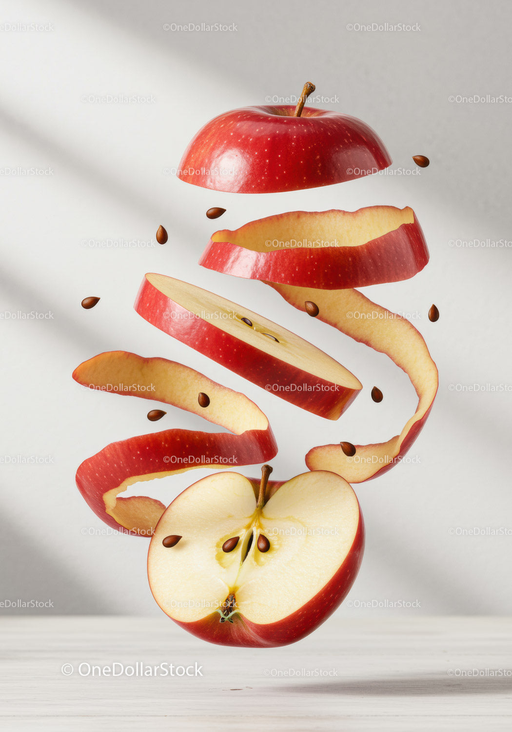 Red apple slices and peel floating with seeds