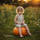 Toddler Sitting Thoughtfully on Large Pumpkin Outdoors