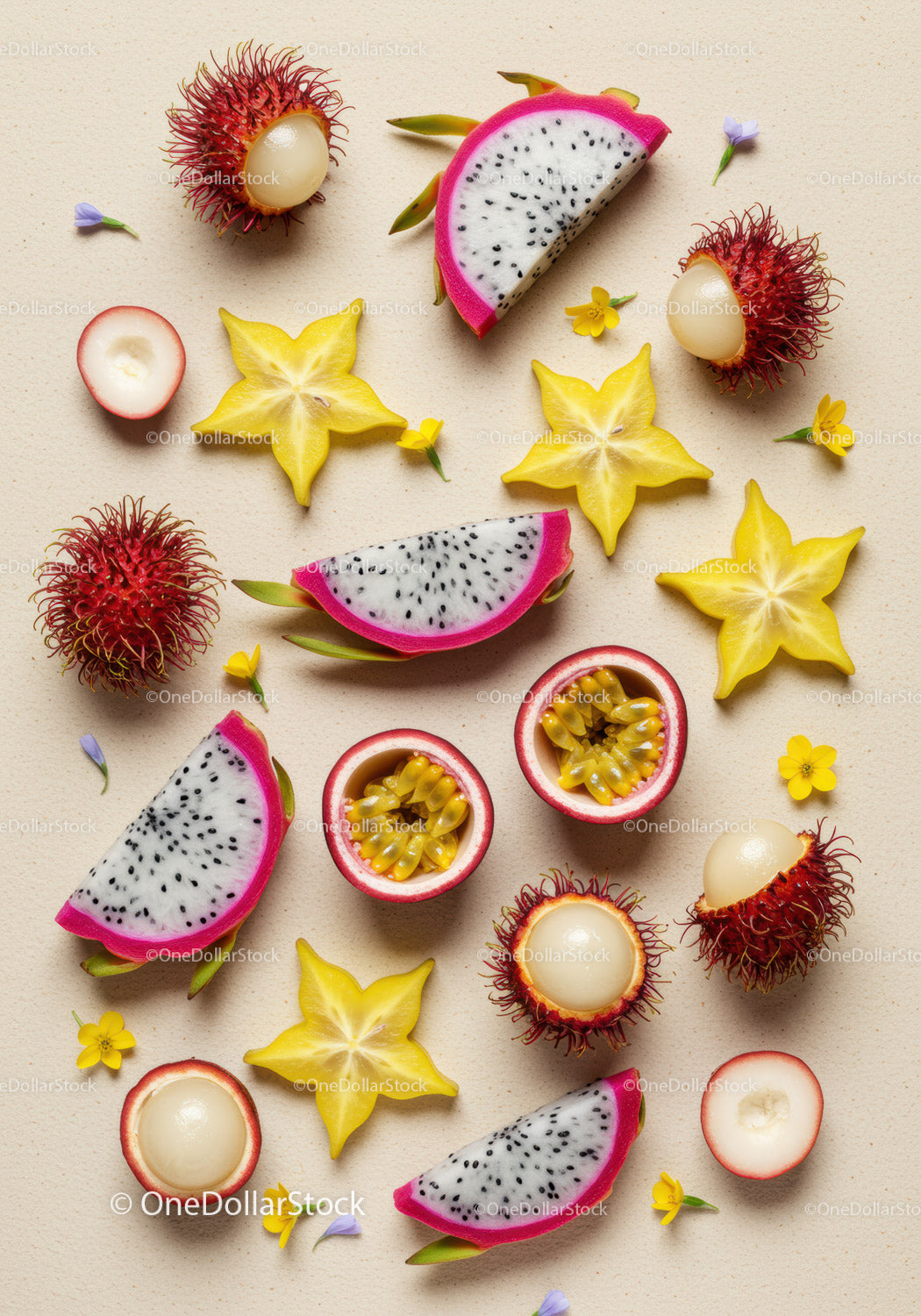 Tropical exotic fruits sliced with small flowers on beige