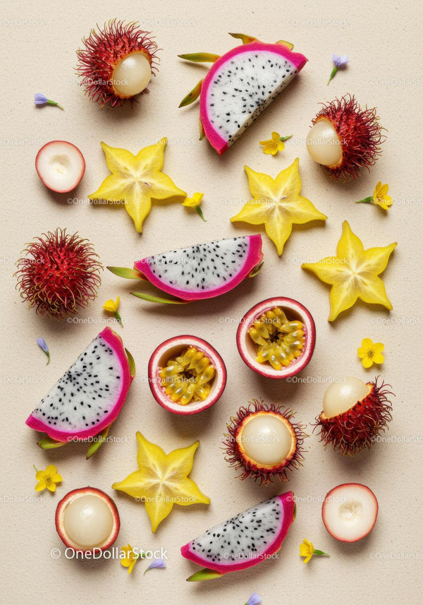 Tropical exotic fruits sliced with small flowers on beige