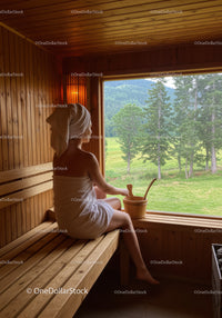 Woman Sitting Relaxing in Sauna with Forest View in Natural Light