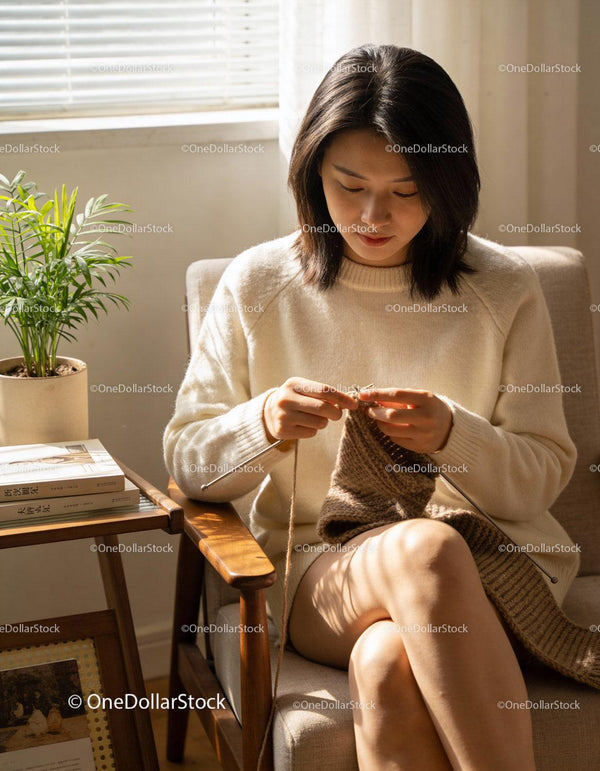 Woman knitting cozy scarf in sunlit room