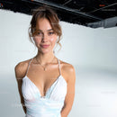 Young Woman in White Dress Smiling on Photo Studio Background