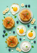 Delicious pancakes topped with syrup and sunny side eggs