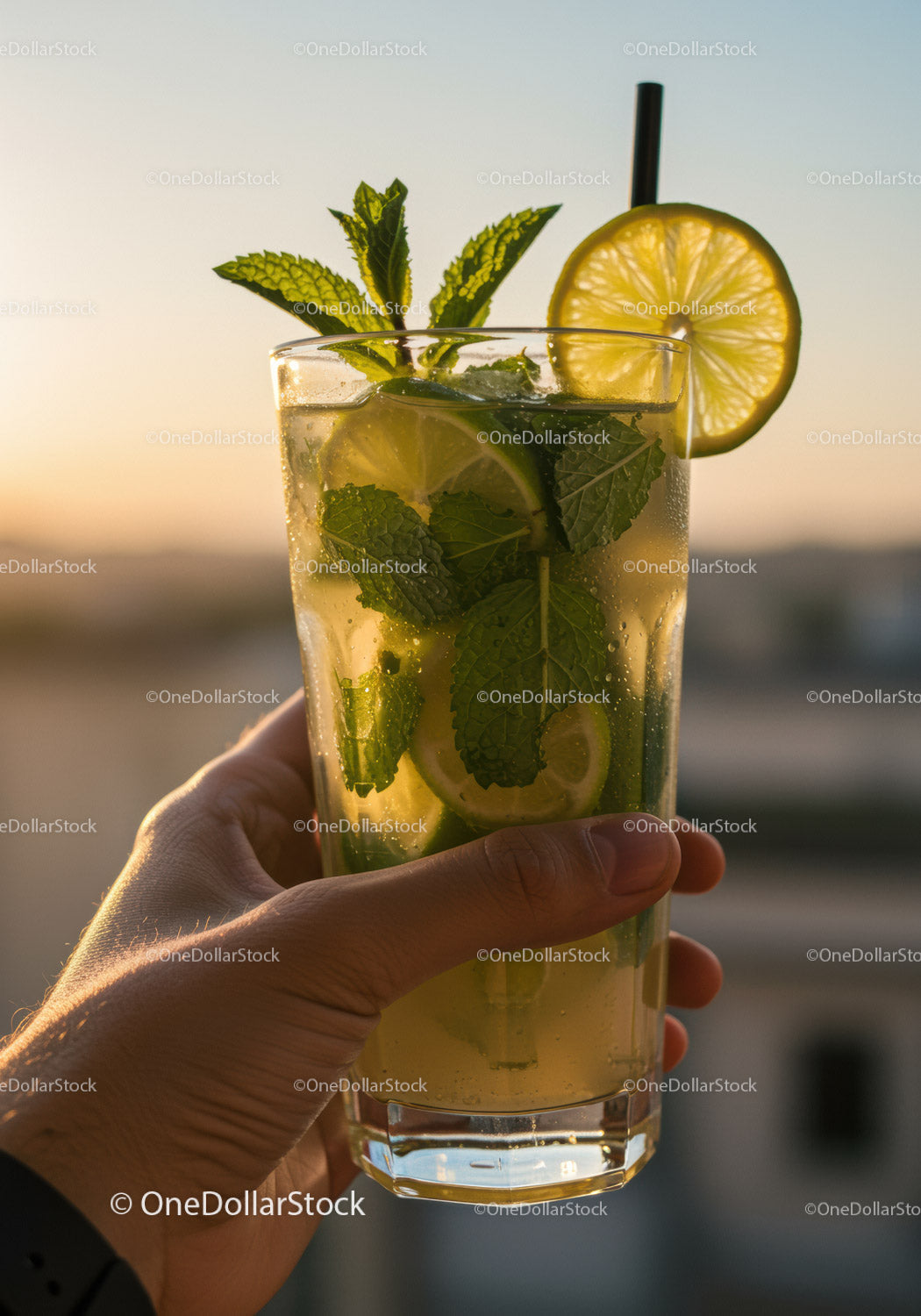 Refreshing Lemon Mint Drink in Hand at Sunset