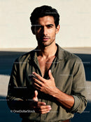 Confident man standing outdoors in natural light