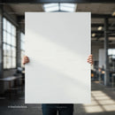 Person Holding Blank White Board in Modern Workspace