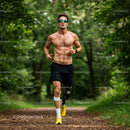 Young Shirtless Man Running in Green Forest on Trail