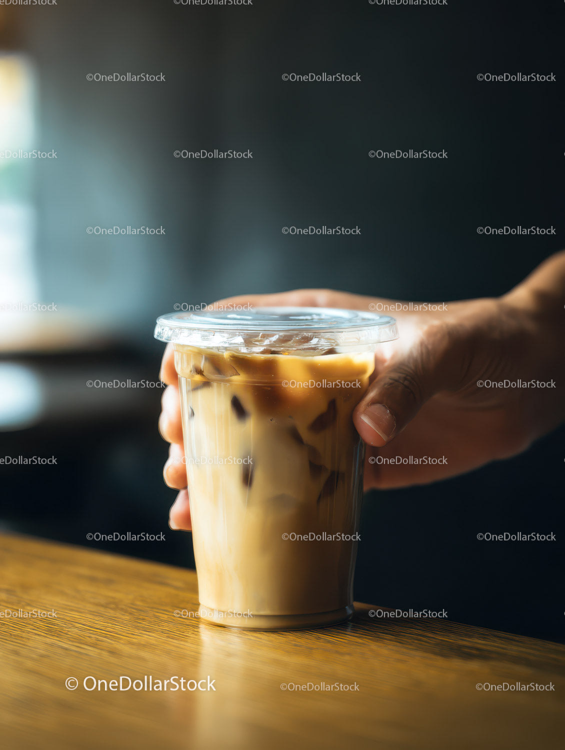 Ice Coffee in Plastic Cup with Ice Cubes on Wooden Surface