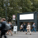 Busy urban street scene with blurred pedestrians in motion