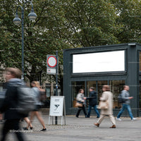 Busy urban street scene with blurred pedestrians in motion